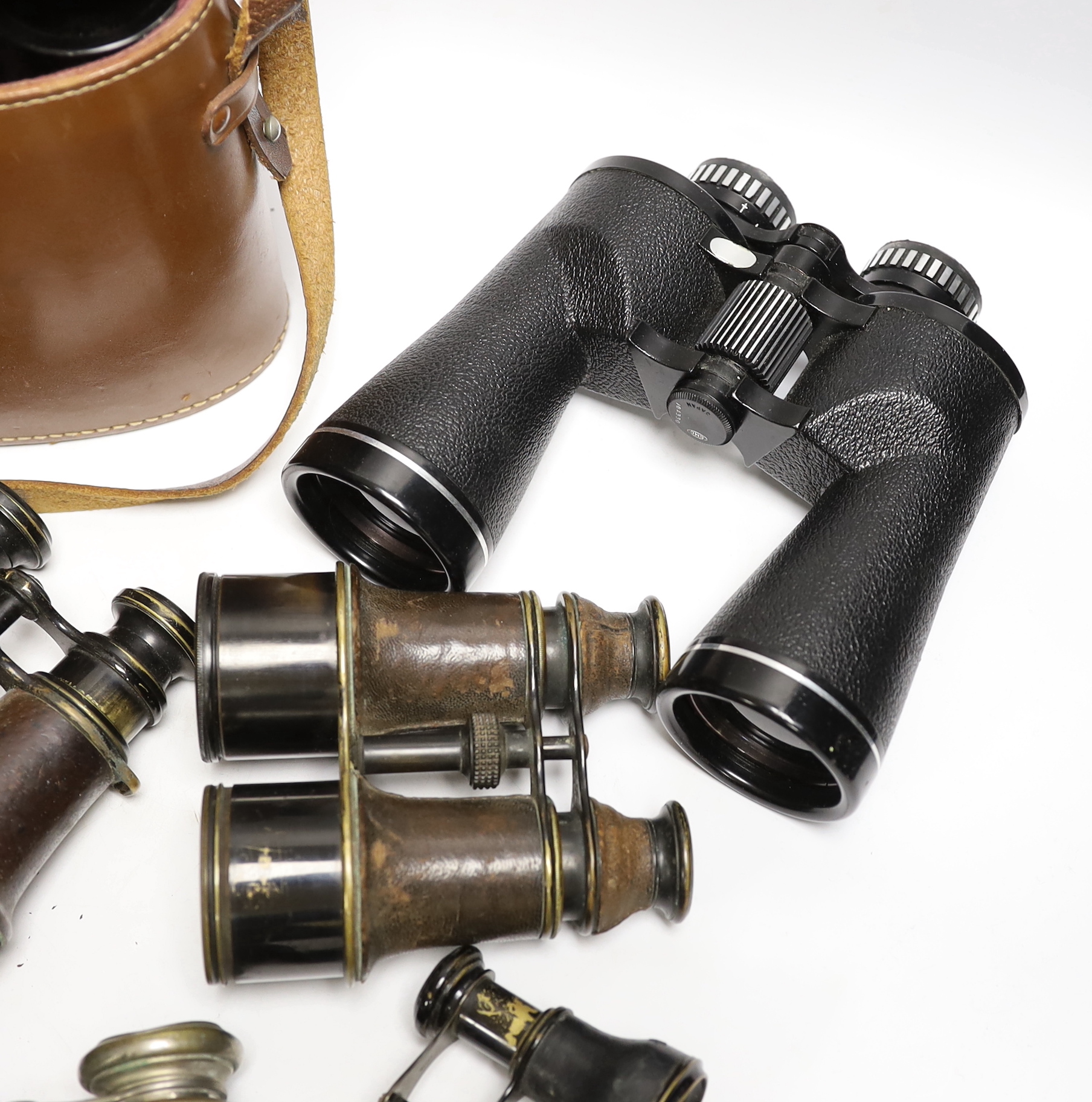 Seven pairs of binoculars including some early 20th century examples, a pair by Ross, etc.